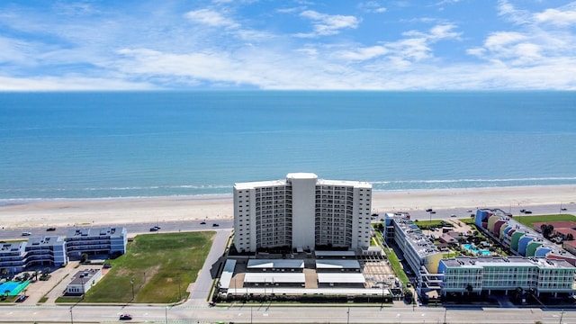 birds eye view of property with a water view and a view of the beach