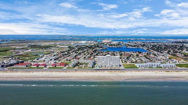 birds eye view of property with a water view and a beach view