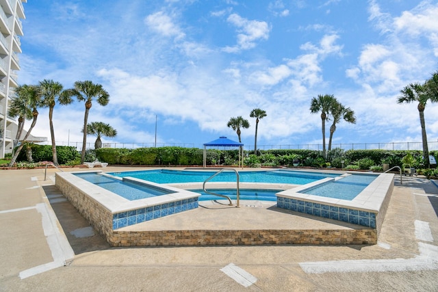 view of pool featuring a community hot tub and a patio