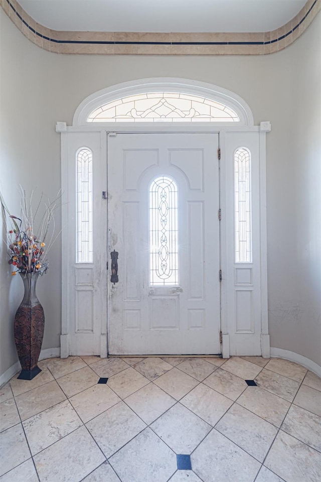 entryway with light tile patterned flooring