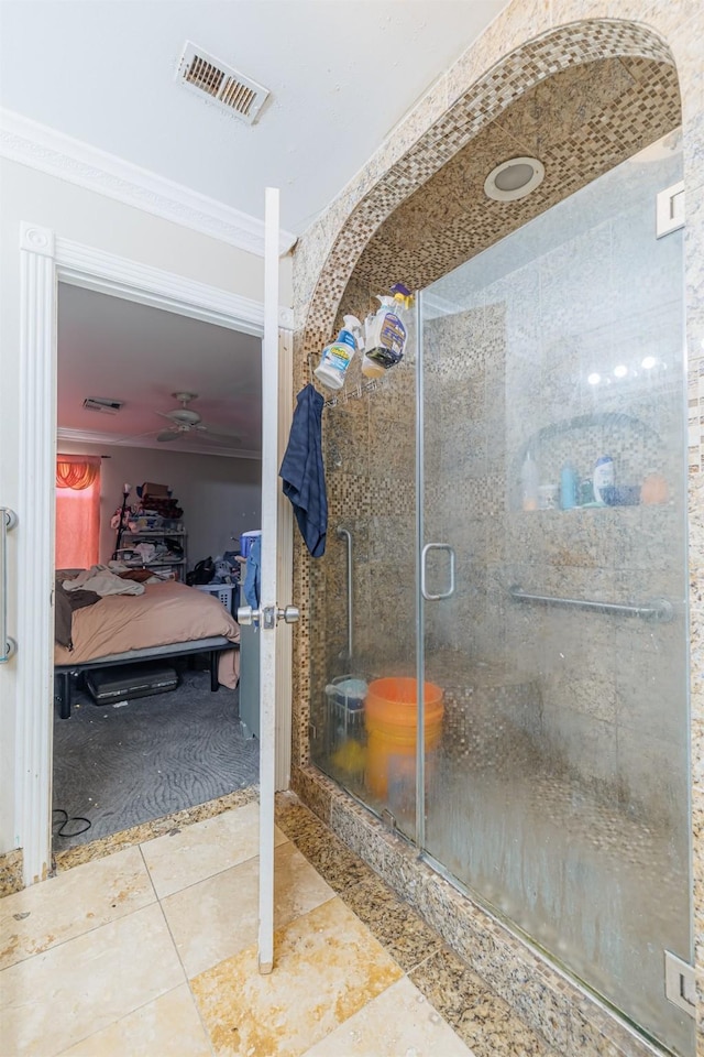 bathroom with tile patterned flooring, crown molding, and walk in shower