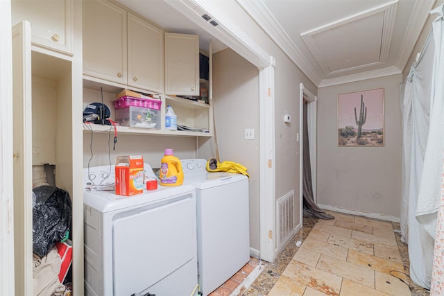 washroom with ornamental molding and washing machine and clothes dryer