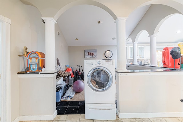 washroom with washer / dryer, decorative columns, and light tile patterned flooring