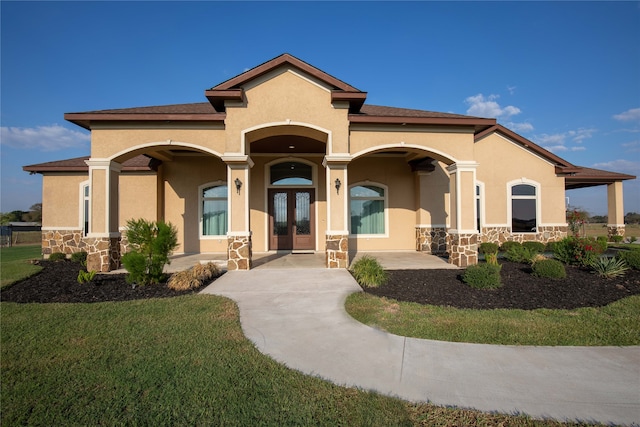 view of front facade with french doors and a front yard