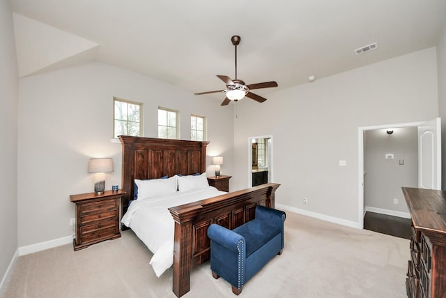 carpeted bedroom featuring lofted ceiling, ceiling fan, and ensuite bathroom