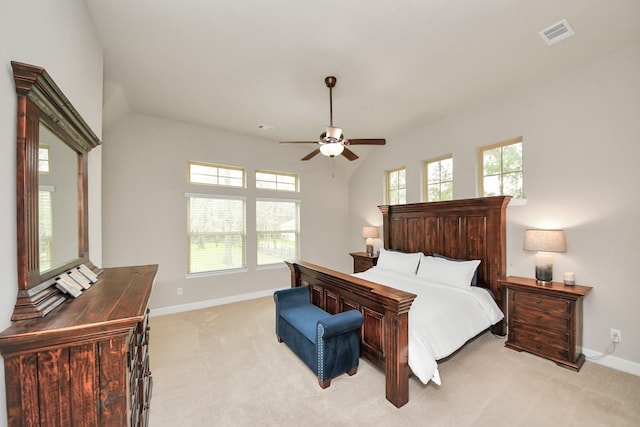 bedroom with ceiling fan, light colored carpet, and vaulted ceiling