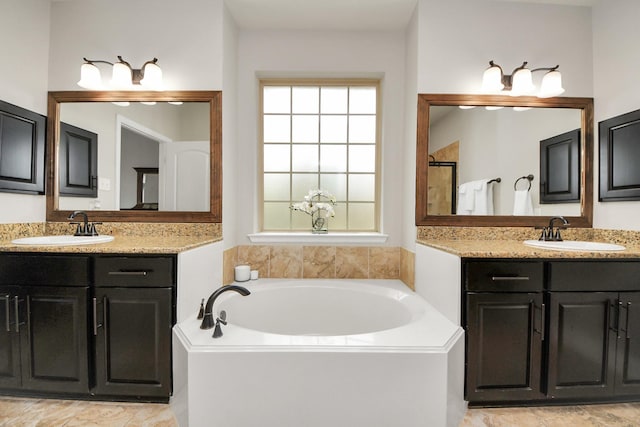 bathroom featuring vanity and a bath