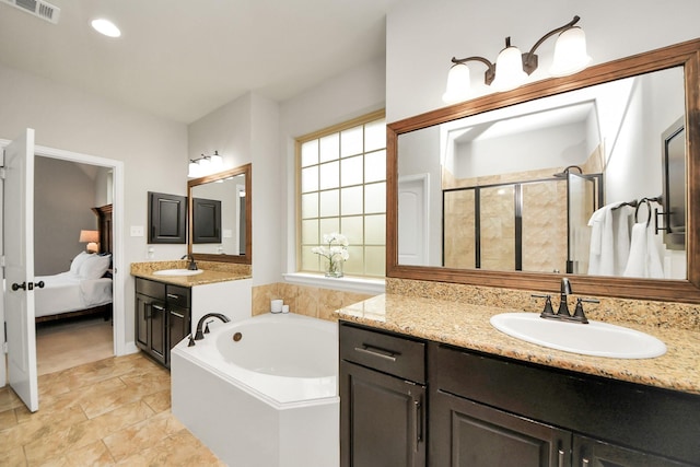 bathroom with shower with separate bathtub, plenty of natural light, and vanity