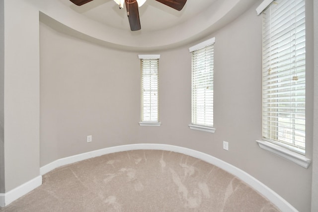 spare room with ceiling fan and carpet