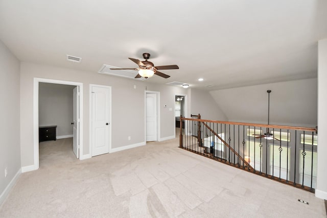 carpeted empty room with vaulted ceiling and ceiling fan