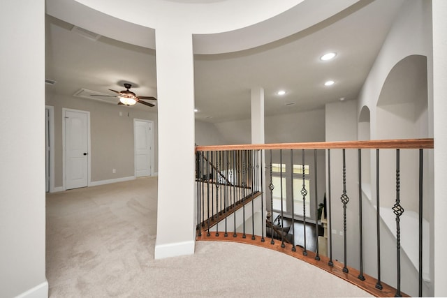 hall featuring light colored carpet