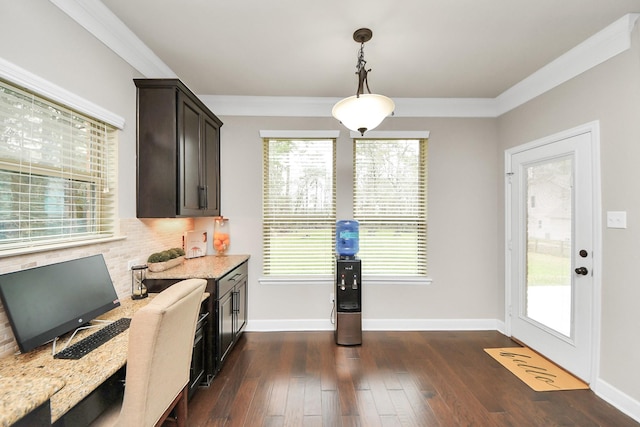 kitchen featuring dark brown cabinetry, ornamental molding, hanging light fixtures, and light stone counters