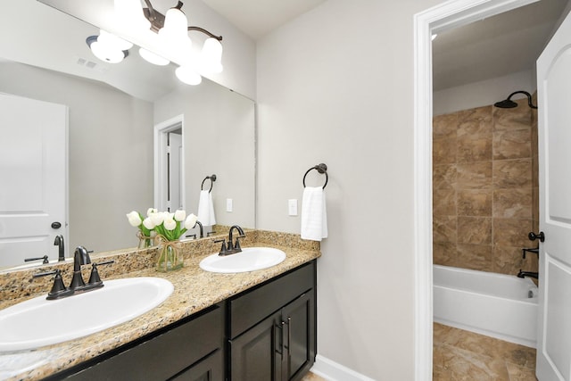 bathroom featuring tiled shower / bath combo, vanity, and tile patterned floors