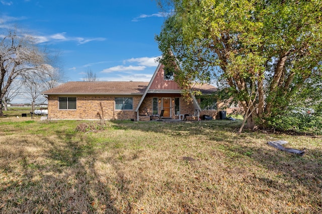 back of property featuring a lawn