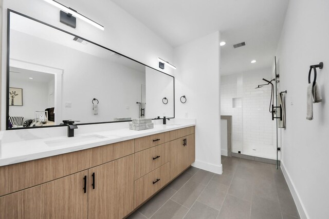 9026 Scott St, Houston, TX 77051 - bathroom featuring visible vents, baseboards, a sink, double vanity, and a stall shower