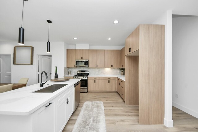 9026 Scott St, Houston, TX 77051 - kitchen with light wood-style floors, light countertops, a sink, and appliances with stainless steel finishes