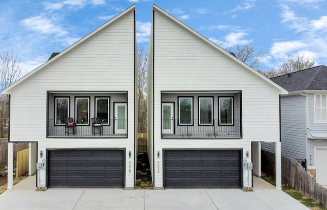 9026 Scott St, Houston, TX 77051 - view of front of house featuring an attached garage, fence, and concrete driveway