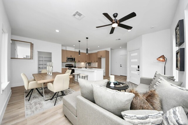 9026 Scott St, Houston, TX 77051 - living room with visible vents, light wood-style flooring, a ceiling fan, and recessed lighting
