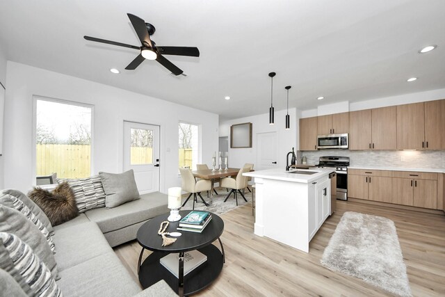 9026 Scott St, Houston, TX 77051 - interior space with a sink, open floor plan, light countertops, and appliances with stainless steel finishes