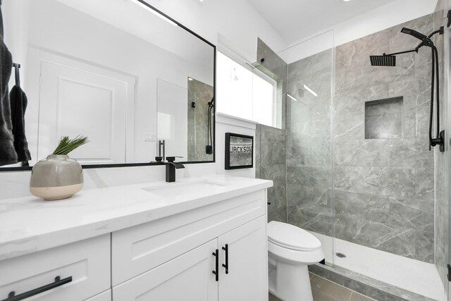 9026 Scott St, Houston, TX 77051 - full bathroom with vanity, a tile shower, and toilet