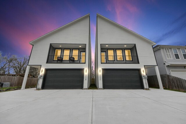 9026 Scott St, Houston, TX 77051 - view of front facade featuring an attached garage, driveway, fence, and a balcony