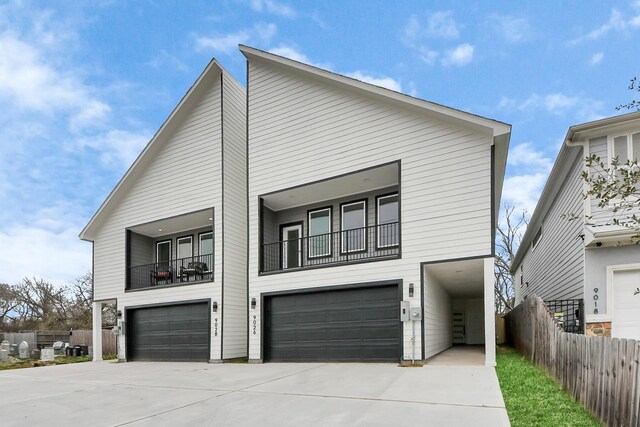 9026 Scott St, Houston, TX 77051 - view of front of property with a balcony, driveway, fence, and an attached garage