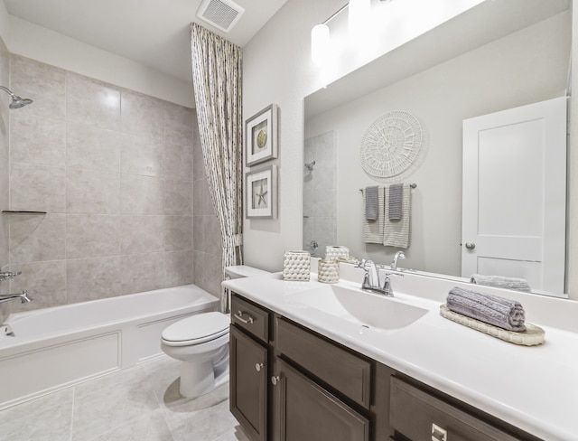 bathroom with shower / tub combination, toilet, vanity, visible vents, and tile patterned floors