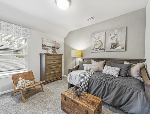 bedroom with light carpet, baseboards, visible vents, and lofted ceiling