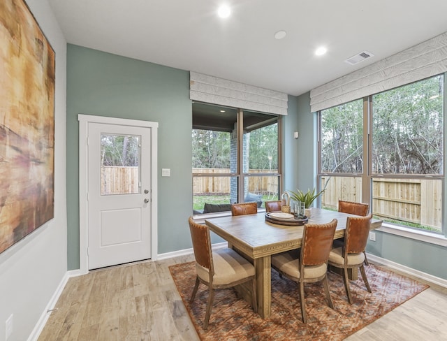 dining space featuring light wood finished floors, baseboards, visible vents, and recessed lighting