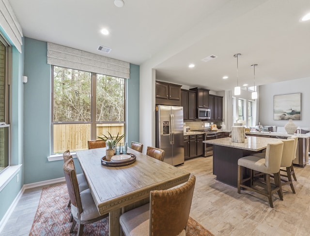 dining area with a wealth of natural light, visible vents, and recessed lighting