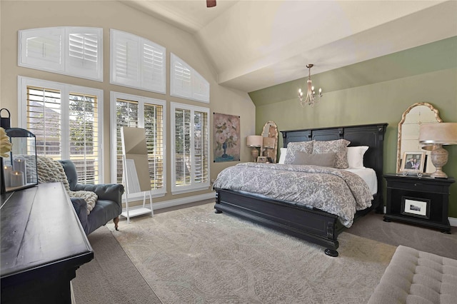 carpeted bedroom with lofted ceiling and a chandelier