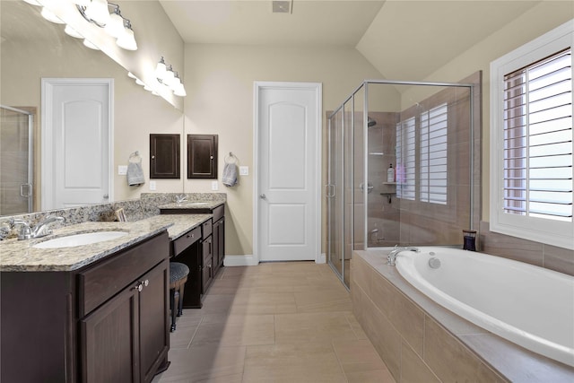 bathroom with lofted ceiling, vanity, independent shower and bath, and tile patterned flooring