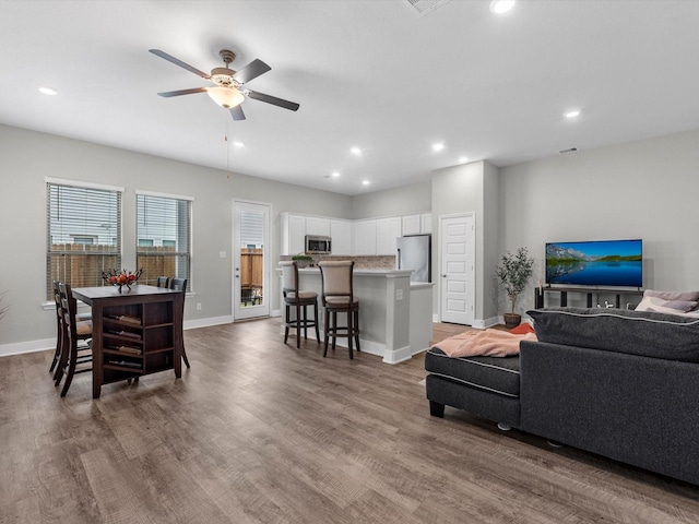 living room featuring dark hardwood / wood-style floors and ceiling fan