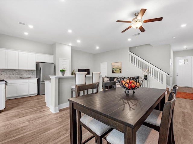 dining area featuring ceiling fan and light hardwood / wood-style flooring