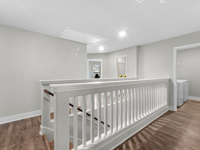 corridor with hardwood / wood-style flooring and washer and clothes dryer