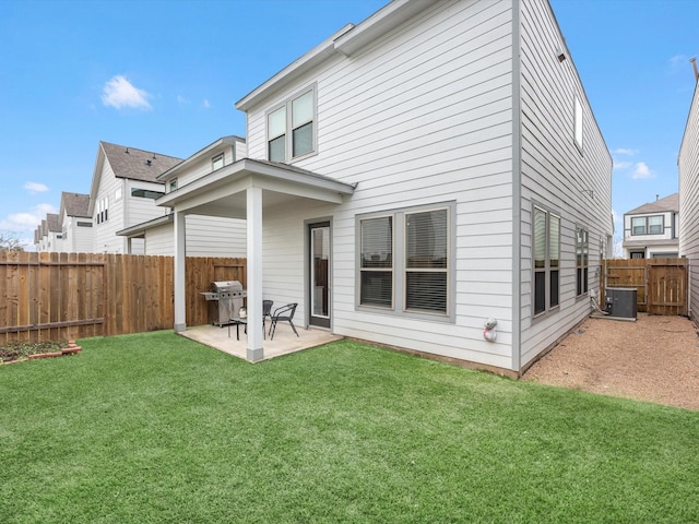 rear view of house featuring cooling unit, a patio, and a lawn