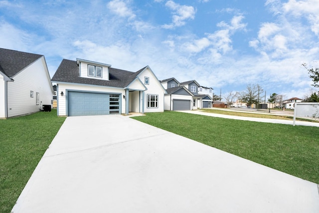 view of front of home featuring a garage, a front yard, driveway, and a shingled roof