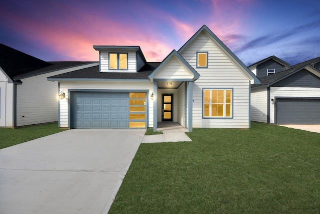 view of front of home featuring a garage, concrete driveway, and a front lawn