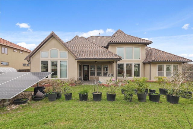 18111 Dockside Landing Dr, Cypress, TX 77433 - back of property featuring stucco siding, ground mounted solar panels, a tile roof, and a yard