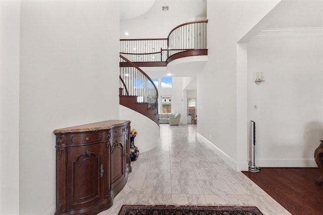 18111 Dockside Landing Dr, Cypress, TX 77433 - foyer entrance featuring stairway, a high ceiling, baseboards, ornamental molding, and light marble finish floors