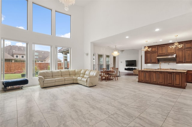 18111 Dockside Landing Dr, Cypress, TX 77433 - living room with a chandelier, light marble finish floors, recessed lighting, and a high ceiling