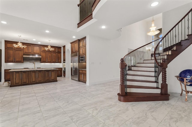 18111 Dockside Landing Dr, Cypress, TX 77433 - stairs with a chandelier, marble look tiles, recessed lighting, a towering ceiling, and baseboards