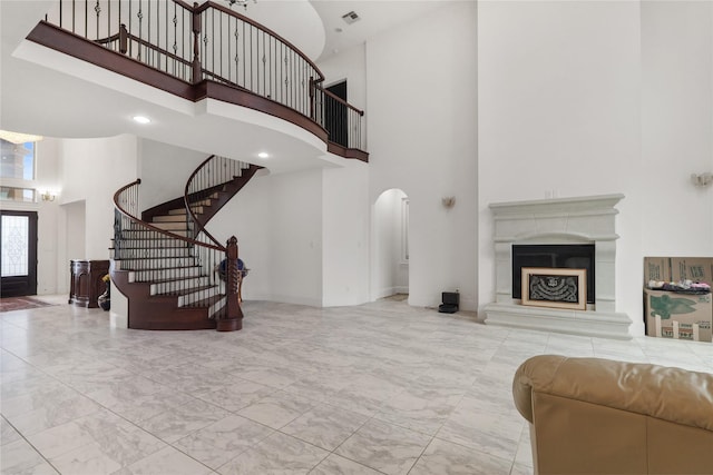 18111 Dockside Landing Dr, Cypress, TX 77433 - living area with a high ceiling, marble finish floors, stairway, arched walkways, and a fireplace with raised hearth