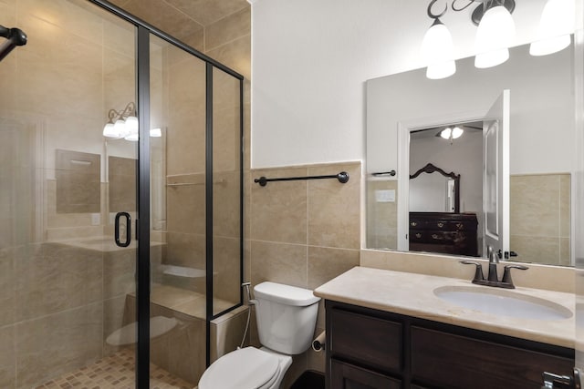 18111 Dockside Landing Dr, Cypress, TX 77433 - bathroom with tile walls, a shower stall, vanity, and toilet
