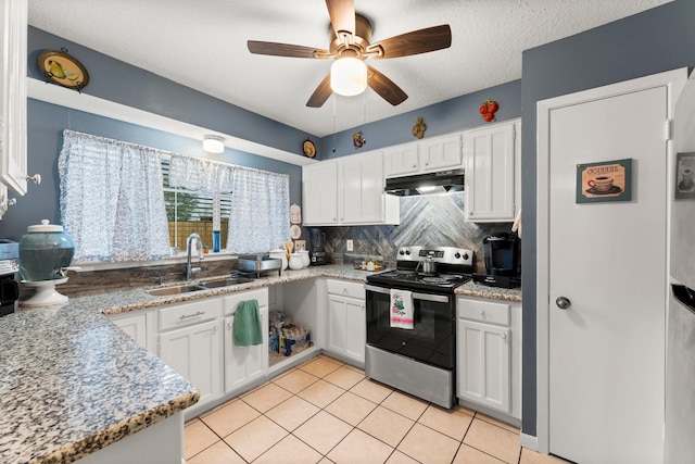 kitchen with light tile patterned flooring, white cabinetry, sink, light stone counters, and stainless steel electric range