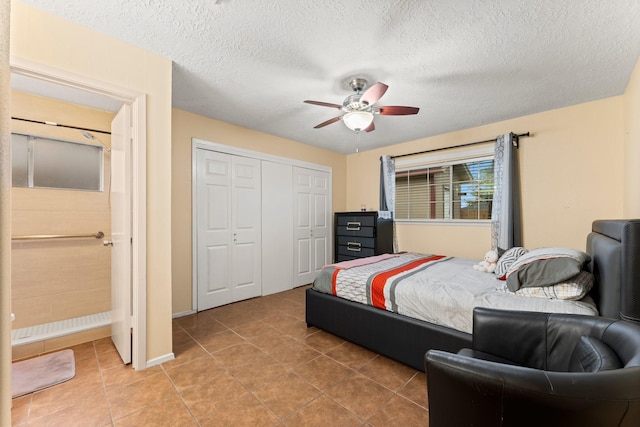 tiled bedroom featuring ceiling fan, a closet, and a textured ceiling