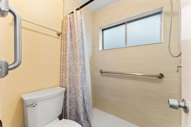 bathroom featuring toilet and walk in shower