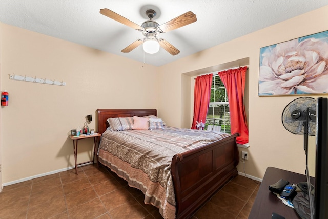 tiled bedroom with a textured ceiling and ceiling fan