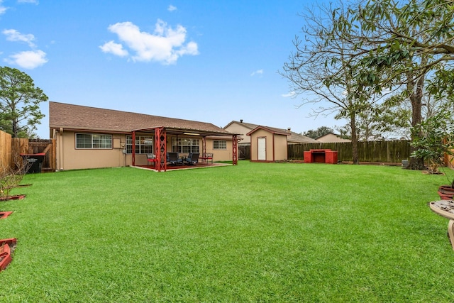 rear view of property featuring a shed, a yard, and a patio area