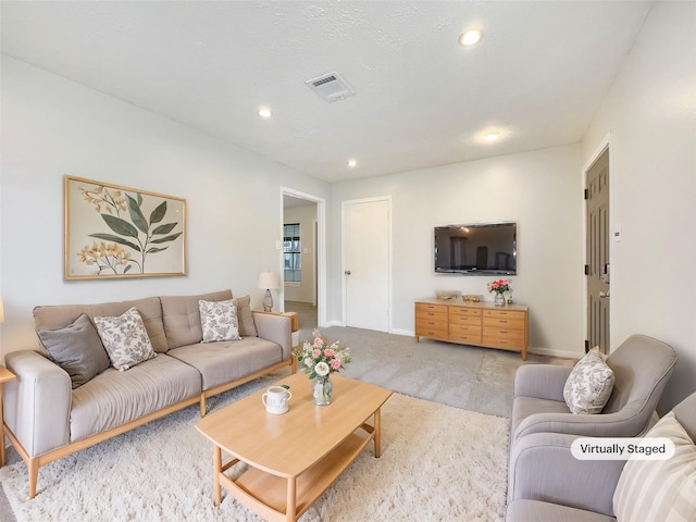 living room featuring light carpet, baseboards, visible vents, and recessed lighting